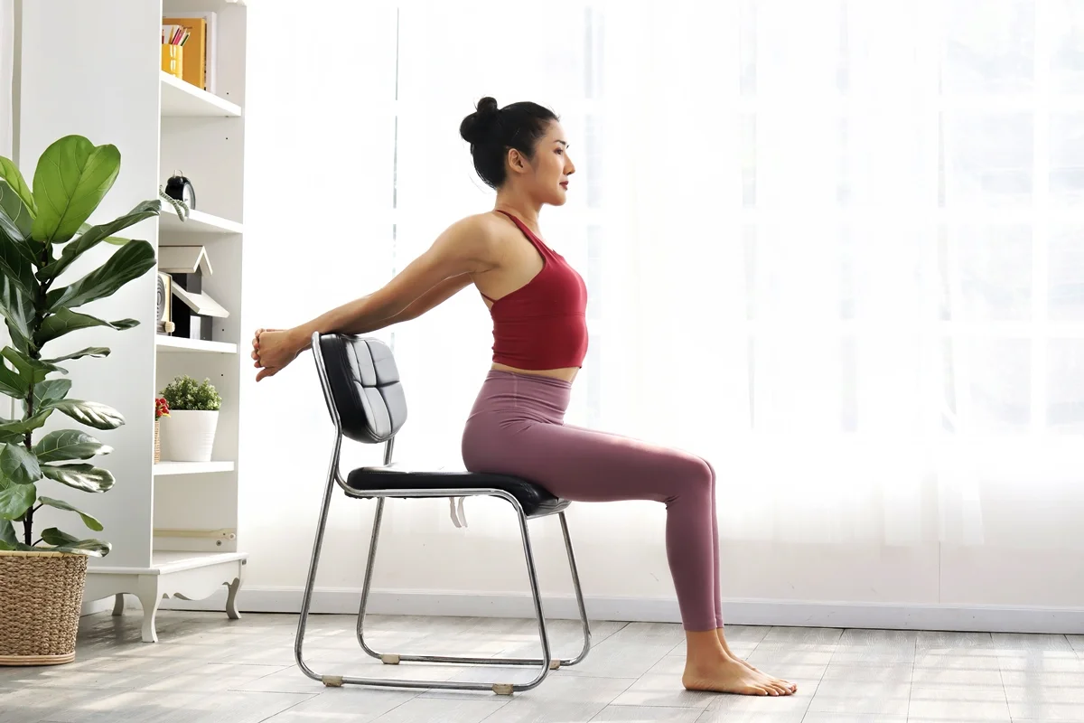 Exercício de pilates com cadeira em casa